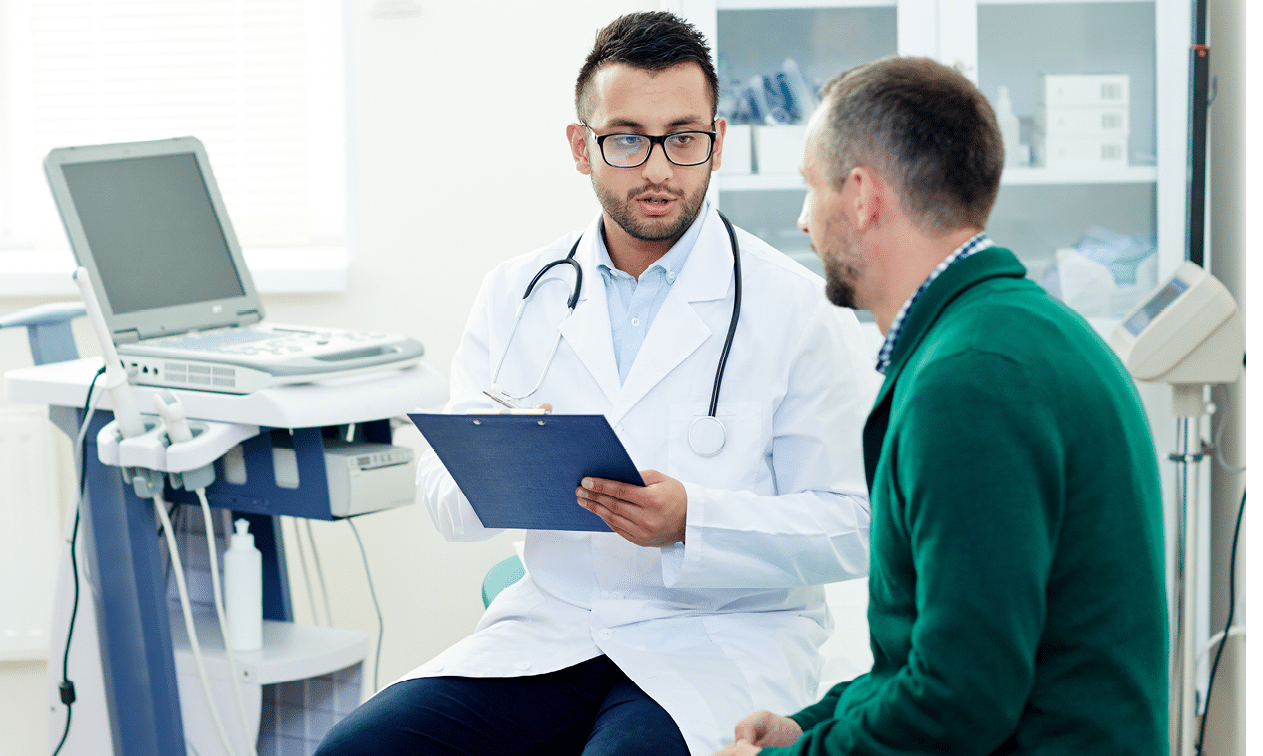 Middle-aged bearded patient having consultation with highly professional physician at modern office, they discussing diagnosis and possible treatment