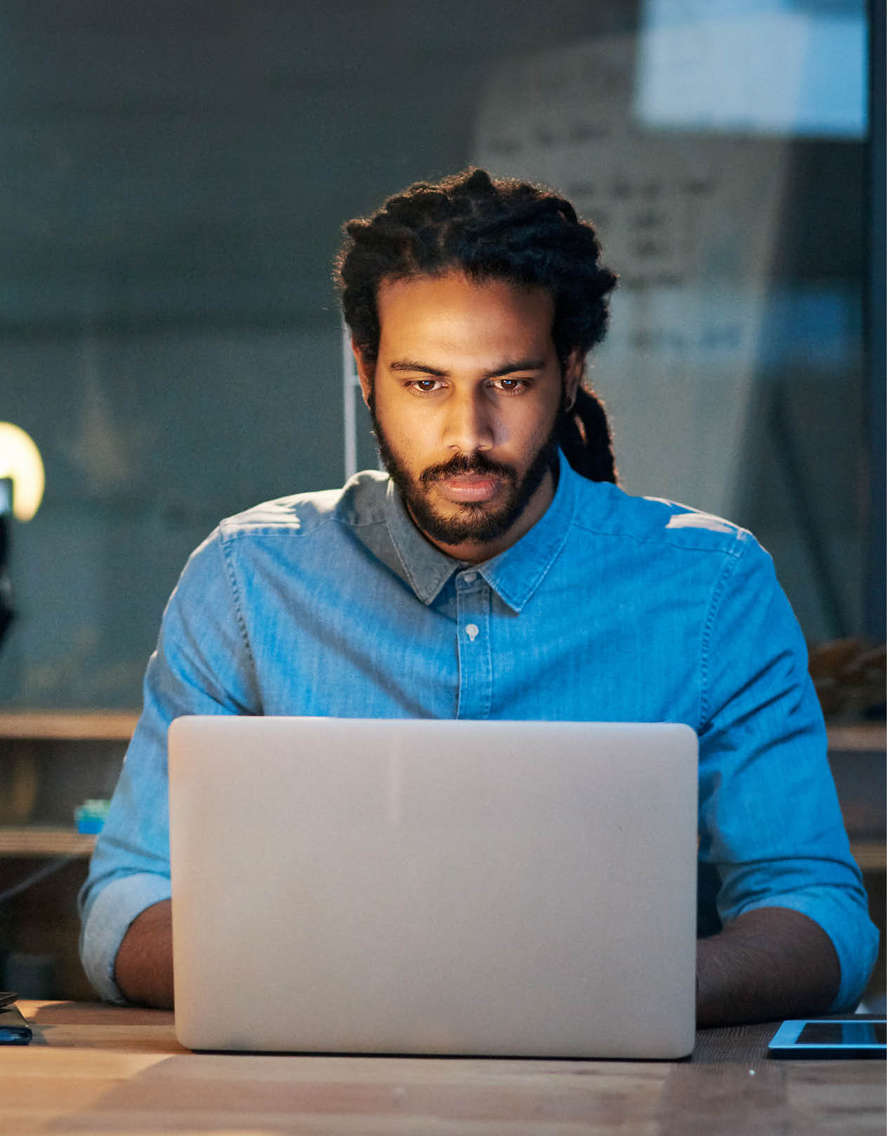 Cropped shot of a young designer working late on a laptop in an office